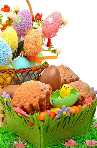 Ostereier im Korb, Schokoladeneier und Muffins auf der Gra — Stockfoto