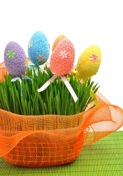 Colorful easter eggs in the flowerbed wih green fresh grass — Stock Photo, Image