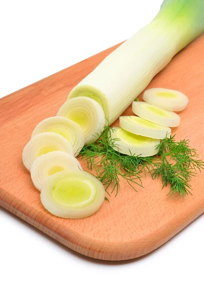Fresh sliced leek and dill on a wooden board — Stock Photo, Image
