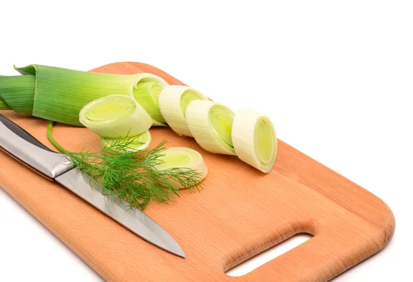Fresh sliced leek and dill on a wooden board — Stock Photo, Image