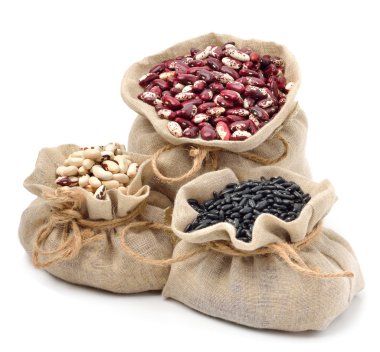 red kidney beans, black beans and black-eyed beans in the sacks clipart