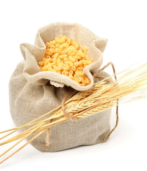 Pasta in bag with wheat ears — Stock Photo, Image