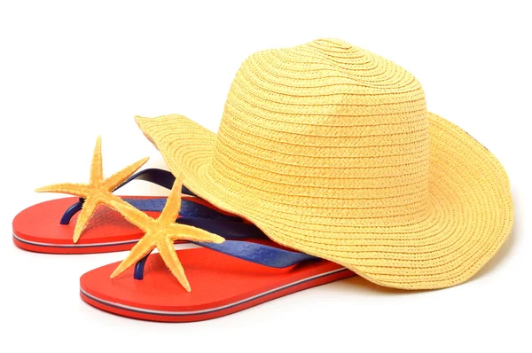 Beach hat, red flip flops with starfishes — Stock Photo, Image