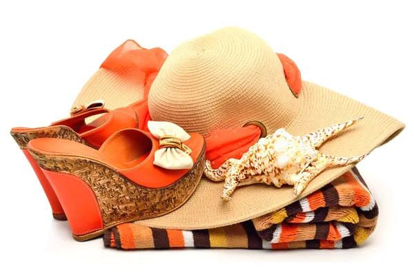 Beach hat, towel, stylish woman shoes and a seashell — Stock Photo, Image