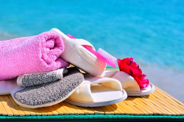 Natural bath sponges, bath slippers, pumice and towel against bl — Stock Photo, Image