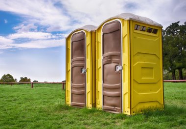 Two yellow portable toilets