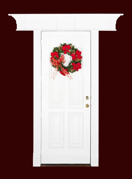 Vánoční květina věnec na bílé dveře — Stock fotografie