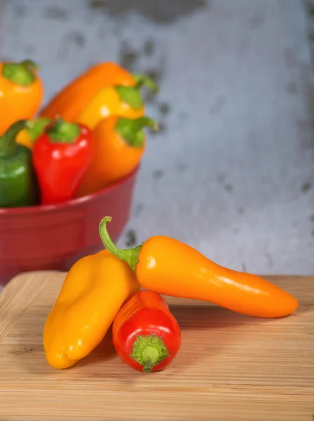 Colorful mini peppers on cutting board — Stock Photo, Image