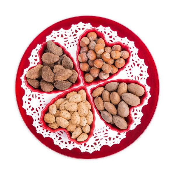 Group of nuts in heart shape bowls — Stock Photo, Image