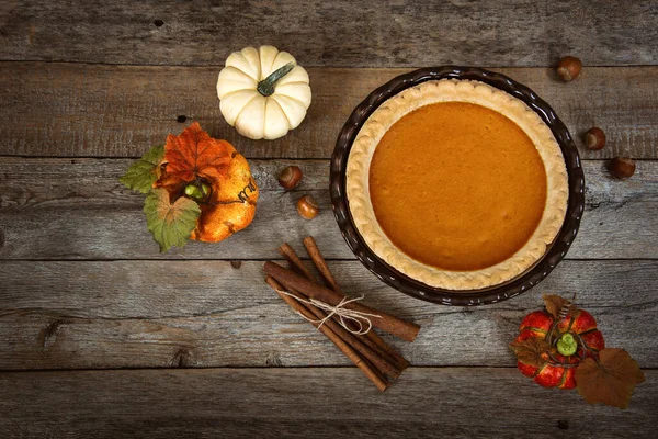 Kürbiskuchen Mit Zimtstangen Und Herbstlicher Dekoration Auf Rustikalem Holztisch Ansicht — Stockfoto