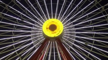 Joyful and Colorful Amusement Park Fun Fair at Night. Ferriswheel, Swing and other Exciting Fun Tools 