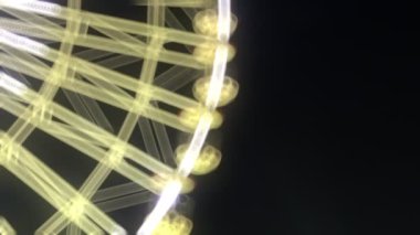 Joyful and Colorful Blurry Amusement Park Fun Fair at Night 