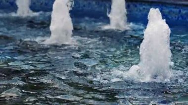 Bubbles and Waves in a Water Fountain in a Pool 