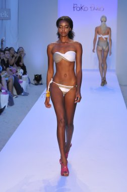 MIAMI - JULY 20: Model walks runway at the Poco Pano Swim Collection for Spring Summer 2013 during Mercedes-Benz Swim Fashion Week on July 20, 2012 in Miami, FL clipart