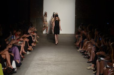 NEW YORK, NY - SEPTEMBER 12: A model walks the runway at the Alexandre Herchcovitch Spring 2012 fashion show during Mercedes-Benz Fashion Week at EYEBEAM on September 12, 2011 in New York City clipart