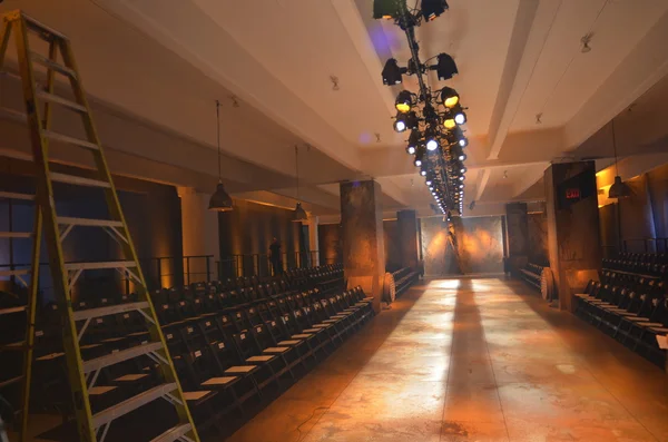 Empty fashion show stage with runway, chairs and lights. — Stock Photo, Image