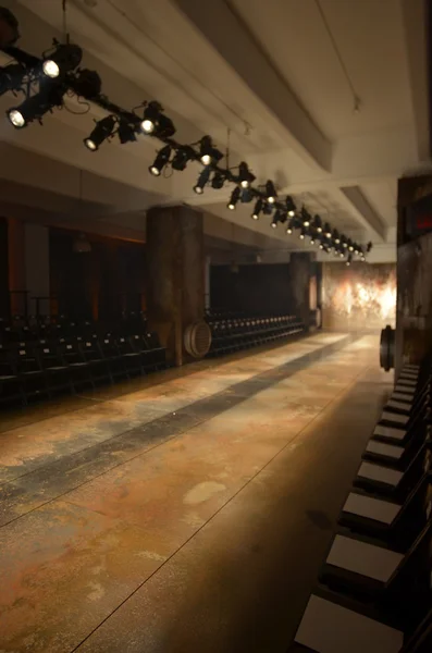 Empty fashion show stage with runway, chairs and lights. — Stock Photo, Image