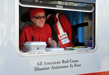NEW YORK, NY - NOVEMBER 09: A mobile Red Cross unit supplies hot lunches for local in the Breezy Point part of Far Rockaway on November 9, 2012 in the Queens borough of New York City. clipart