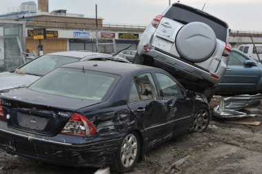 QUEENS, NY - NOVEMBER 11: Deamaged cars at parking lot in the Rockaway due to impact from Hurricane Sandy in Queens, New York, U.S., on Novemeber 11, 2012. clipart