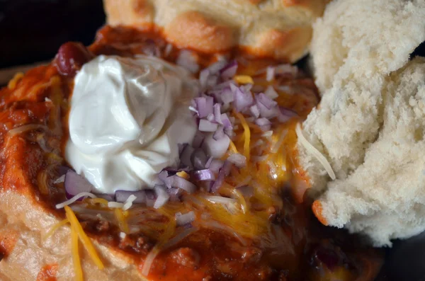 Sopa en un tazón de pan con crema agria y cebolla — Foto de Stock