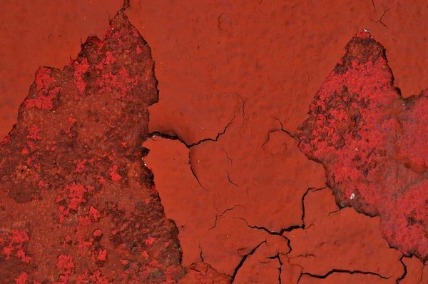 Pintura roja astillada sobre fondo metálico oxidado texturizado — Foto de Stock