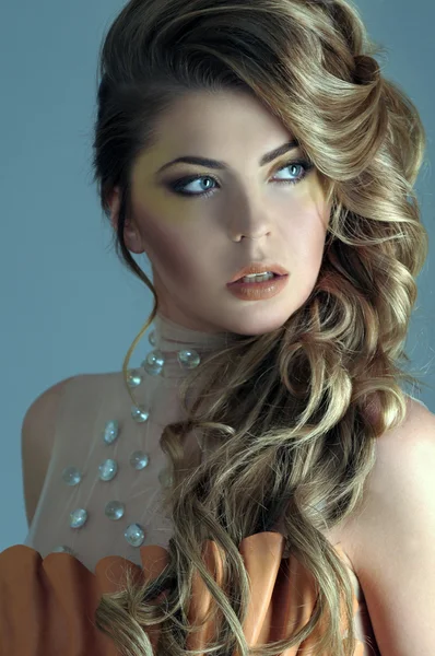 Portrait of beautiful female model on light blue background — Stock Photo, Image