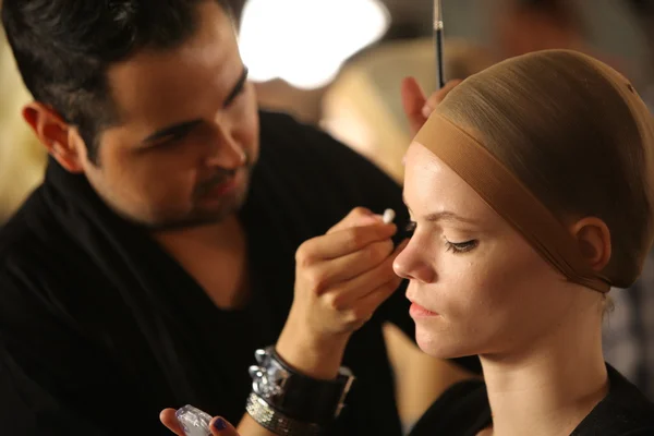 NEW YORK- SEPTEMBER 11: Make-up artist applying makeup to model backstage at the Blonds Collection for Spring/ Summer 2013 — Stock Photo, Image