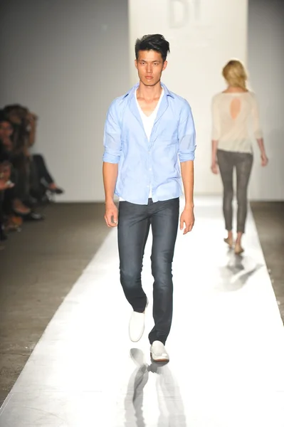 A model walks the runway at the DL 1961 Premium Denim spring 2013 fashion show Stock Image