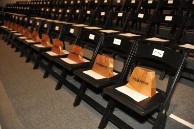 NEW YORK, NY - SEPTEMBER 08: A general view frontstage, seats and gift bags at the Katya Leonovich show during Spring 2013 Mercedes-Benz Fashion Week at The Studio Lincoln Center clipart