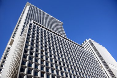 Looking up a skyscraper office block in New York City clipart
