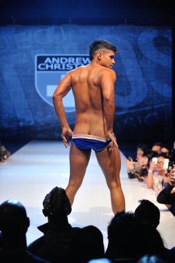 Los Angeles - March 12: A male model walks the runway at the Andrew Christian Fall Winter 2013 fashion show during Project Ethos Fashion event at club Avalon on March 12, 2013 in Los Angeles, CA clipart