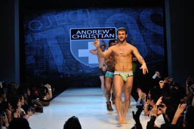 Los Angeles - March 12: Male models walk the runway finale at the Andrew Christian Fall Winter 2013 fashion show during Project Ethos Fashion event at club Avalon on March 12, 2013 in Los Angeles, CA clipart