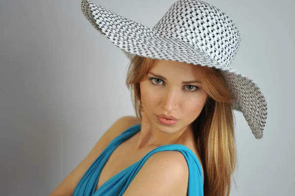 Portrait of young sexy blond girl wearing summer hat and blue dress — Stock Photo, Image