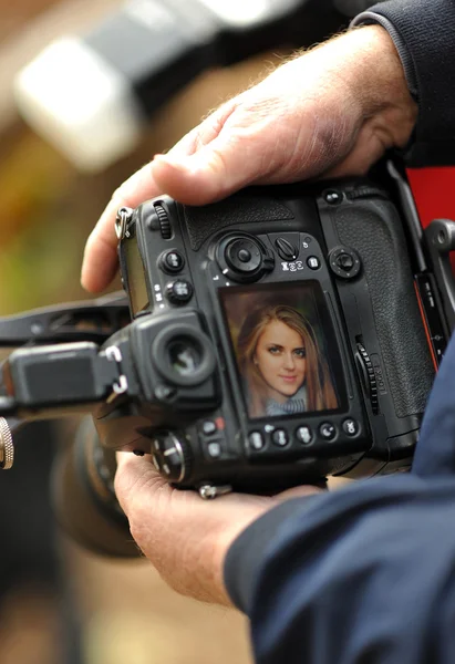 Câmera DSLR na mão mostrando visualização de tela — Fotografia de Stock