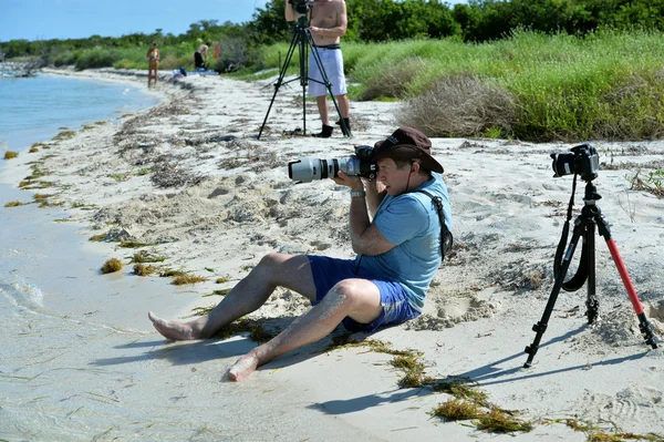 Fotógrafo sentado na praia — Fotografia de Stock