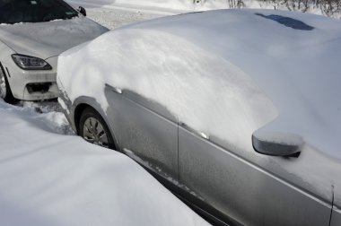 Car under deep fresh snow in NYC clipart