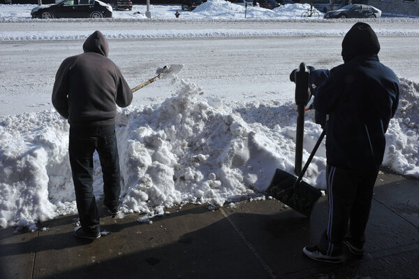 People cleaning streets after snow storm