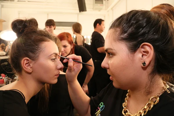 Make-up artist applying lipstick to model face — Stock Photo, Image