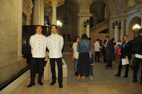 Waiters serve before Ralph Lauren show