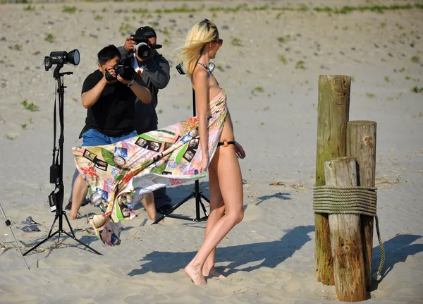 Fotógrafos tomando fotos de modelo en la playa —  Fotos de Stock