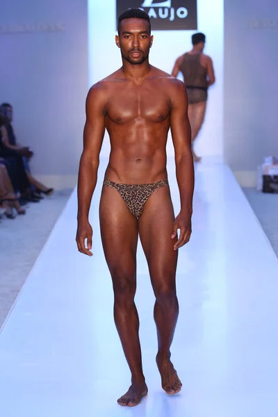 Model walks runway at AZ Araujo Swimwear collection