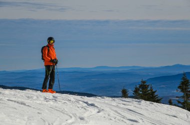 Skier standing on the top of Peak Mansfield Summit at Stowe Vermont Mountain Resort.