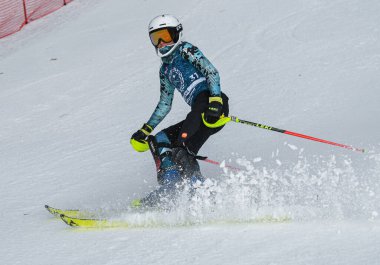 VERMONT - DECEMBER, 17: Young skiers from Mount Mansfield Academy practising on Spruce Peak Race Course Stowe Mountain Resort on December 17, 2021 in Stowe, VT, USA.