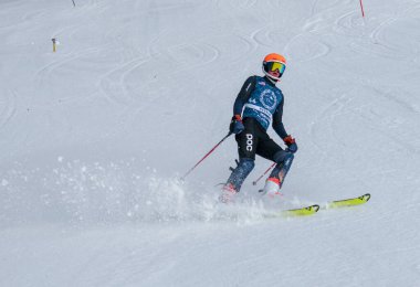 VERMONT - DECEMBER, 17: Young skiers from Mount Mansfield Academy practising on Spruce Peak Race Course Stowe Mountain Resort on December 17, 2021 in Stowe, VT, USA.