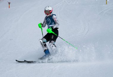 VERMONT - DECEMBER, 17: Young skiers from Mount Mansfield Academy practising on Spruce Peak Race Course Stowe Mountain Resort on December 17, 2021 in Stowe, VT, USA.
