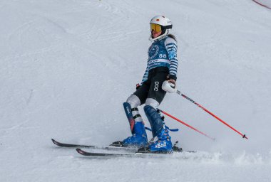 VERMONT - DECEMBER, 17: Young skiers from Mount Mansfield Academy practising on Spruce Peak Race Course Stowe Mountain Resort on December 17, 2021 in Stowe, VT, USA.
