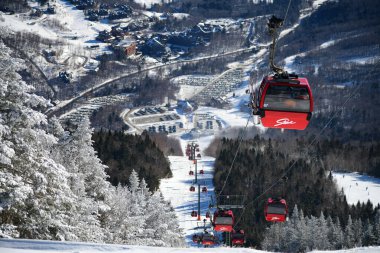 Easy way Gondola lift at Stowe Ski Resort in Vermont, view to the Spruce Peak village.
