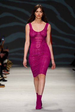 MİLAN, İTALYA - 24 Şubat 2022 'de Milano Moda Haftası / Kış 2023' te İtalya 'nın Milano kentinde düzenlenen Genny defilesinde bir model podyumda yürüyor..