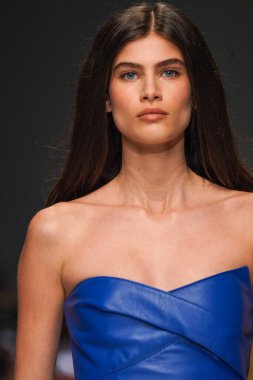 MİLAN, İTALYA - 24 Şubat 2022 'de Milano Moda Haftası / Kış 2023' te İtalya 'nın Milano kentinde düzenlenen Genny defilesinde bir model podyumda yürüyor..