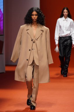 MILAN, İTALYA - 25 Şubat 2022 'de Milan Moda Haftası / Kış 2023' te İtalya 'nın Milano kentinde Tod defilesinde bir model podyumda yürüyor..